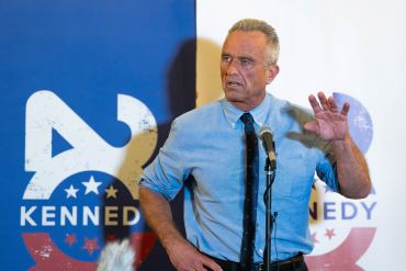 A photo of Robert F. Kennedy Jr. speaking at a microphone.