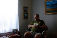 A photo shows Jerry Bilinski posing for a portrait by a window, casting the right side of his face in shadow.