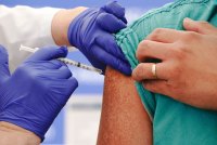 A photo of a person receiving a covid-19 vaccine.