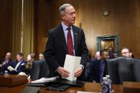 A photo of Martin O'Malley standing inside a Senate committee hearing room.