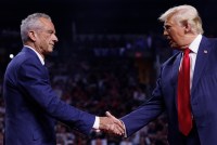 A photo of Donald Trump shaking hands with Robert F. Kennedy Jr. at a campaign rally.